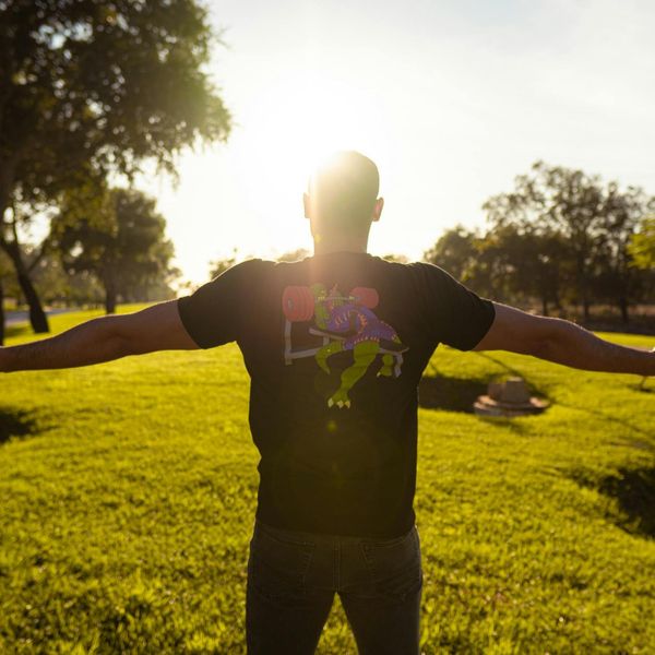 Person feeling energized and stretching outdoors with a serene background.